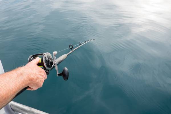 A man holds a fishing pole