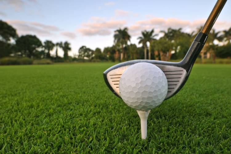 A golfer tees up on a Panama City Beach golf course