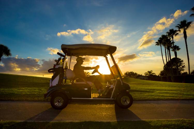 A golf cart drives on a Panama City Beach course