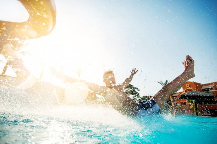 A man slides down a waterslide